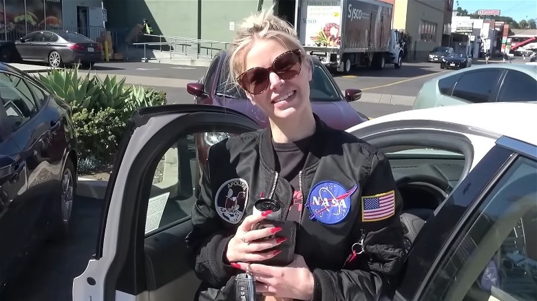 Ariana Madix wearing NASA jacket smiling