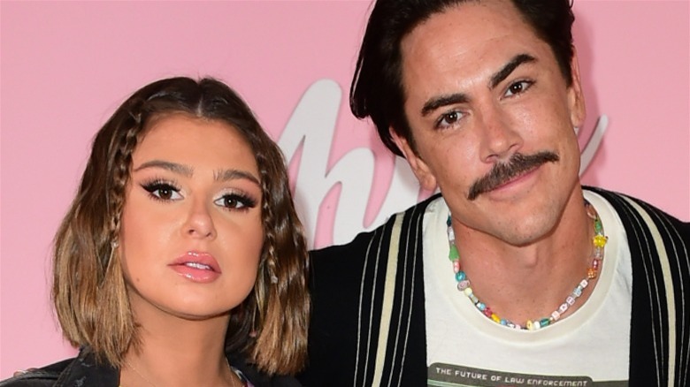 Raquel Leviss & Tom Sandoval in front of pink background