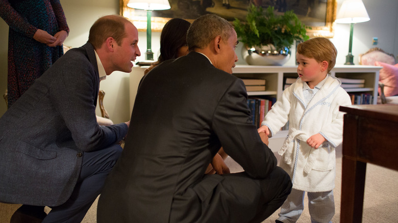 Prince George, Prince William, Barack and Michelle Obama at an event 