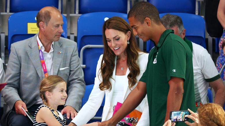 Princess Charlotte and Warren Lawrence shake hands 