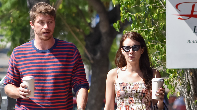 Garrett Hedlund and Emma Roberts walking in the street