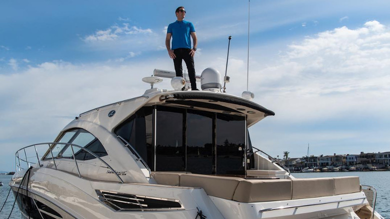 Tarek El Moussa standing on his boat