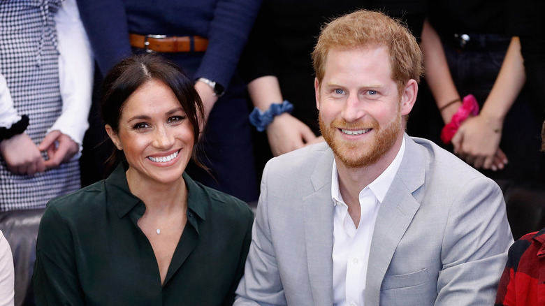 Meghan Markle and Prince Harry smiling in crowd