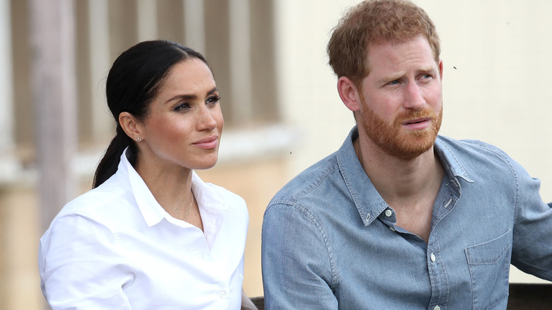 Meghan Markle and Prince Harry looking into distance