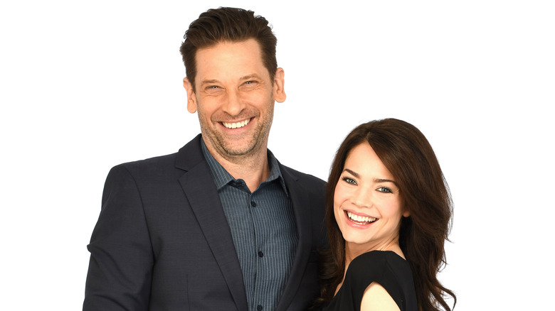 Roger Howarth and Rebecca Herbst posing