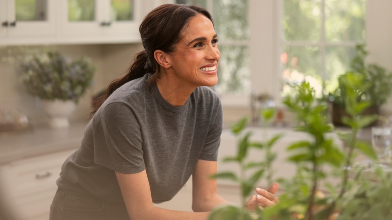 Meghan Markle smiling in a production still from her show 