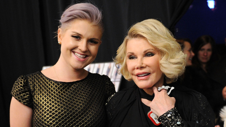 Kelly Osbourne smiles next to Joan Rivers