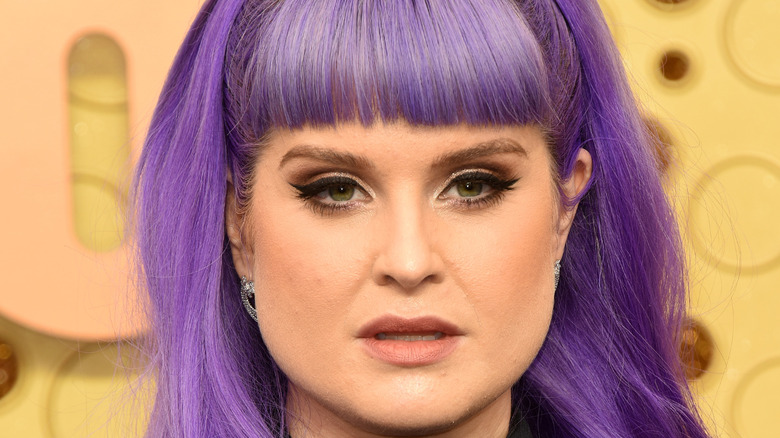 Kelly Osbourne poses at an event