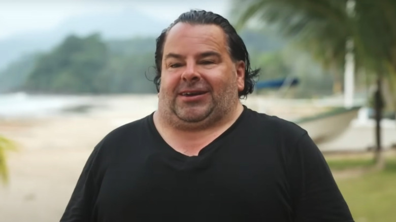 Big Ed talking on a beach