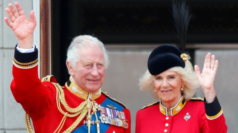 King Charles and Queen Camilla waving