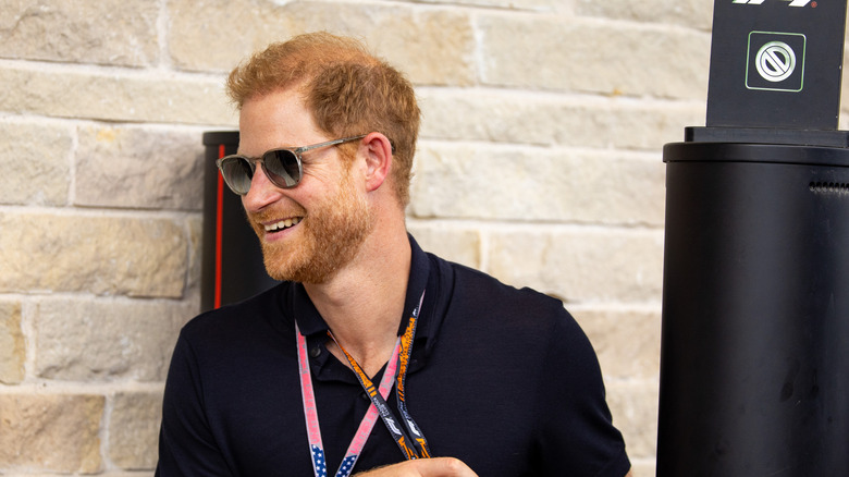 Prince Harry wearing sunglasses, smiling