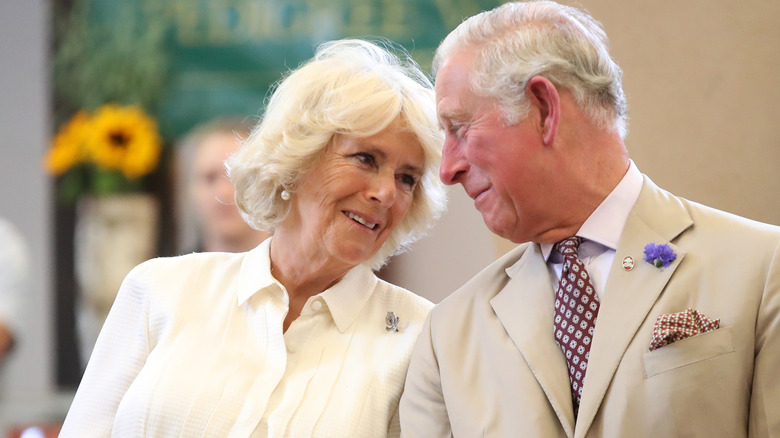 Queen Camilla and King Charles smiling at each other