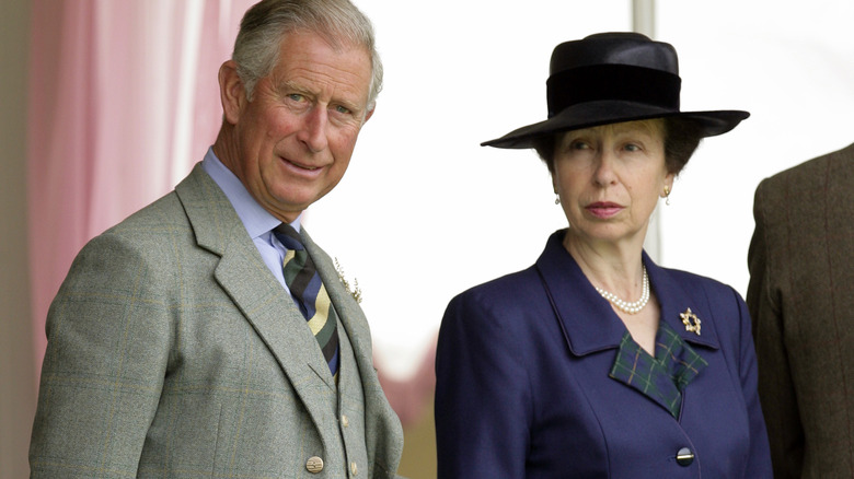 King Charles III smiling with Princess Anne
