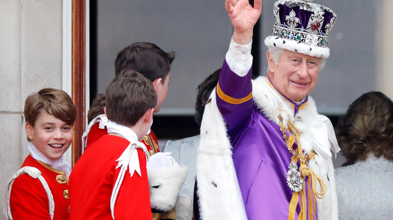 King Charles pictured with Prince George behind him