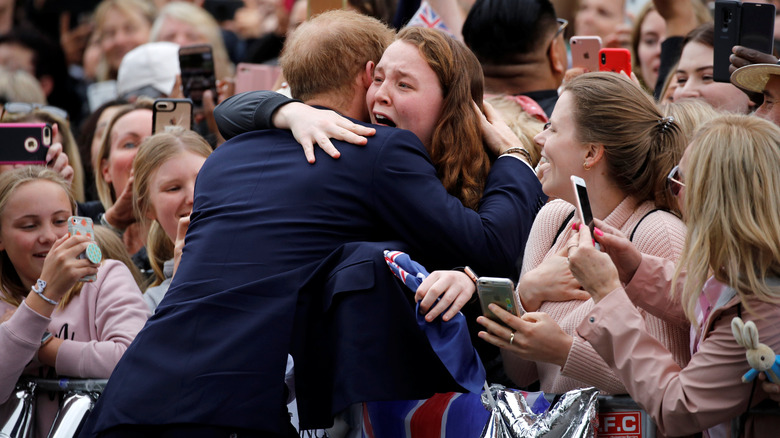 Prince Harry hugging a fan