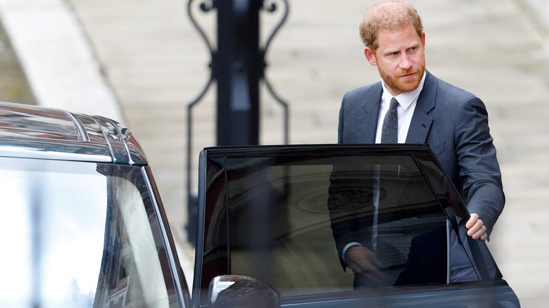 Prince Harry closing his car door