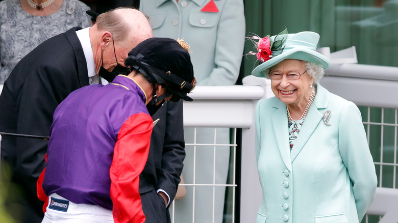 Men bowing to the queen