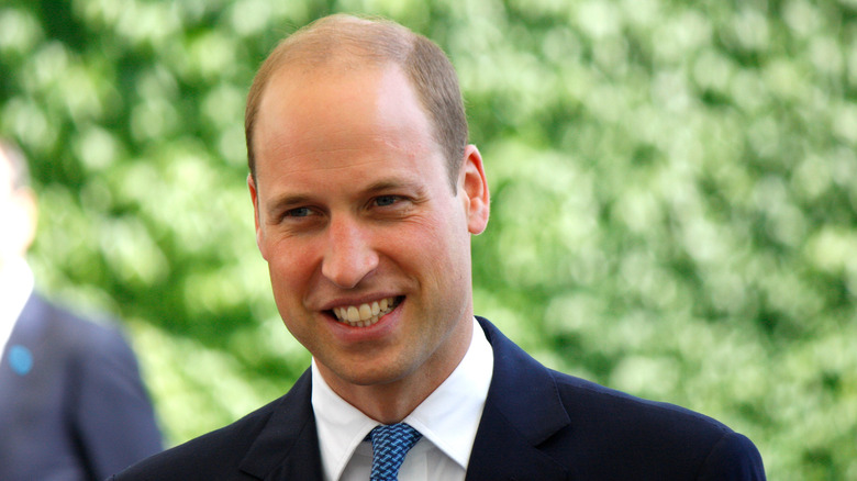 Prince William in suit and tie smiling