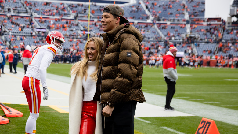 Brittany Mahomes and Jackson Mahomes posing for photos