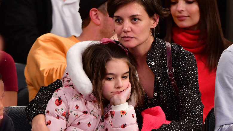 Katie Holmes hugs Suri Cruise at basketball game