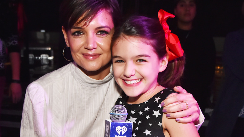 Katie Holmes hugs smiling Suri Cruise