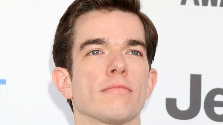 John Mulaney posing at event