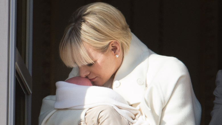 Charlene kisses her baby