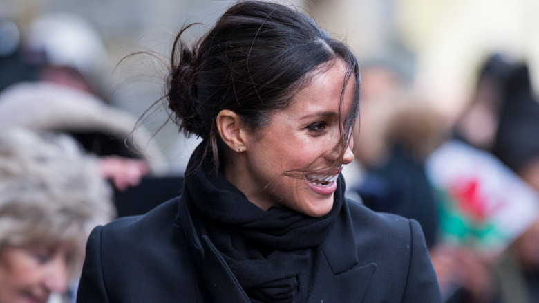 Meghan Markle with her hair in a messy bun