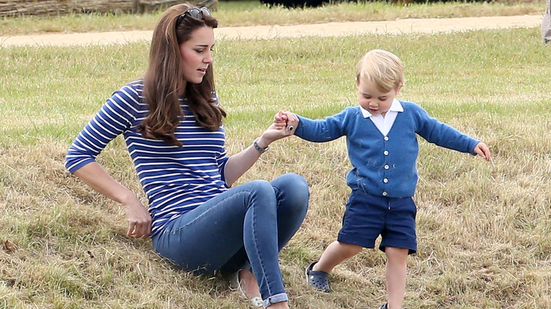 Prince George holding Princess Catherine's hand