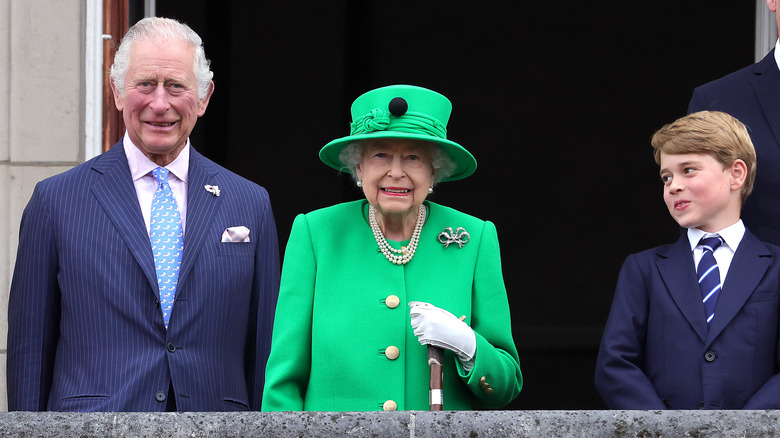 Prince George posing with the queen and King Charles