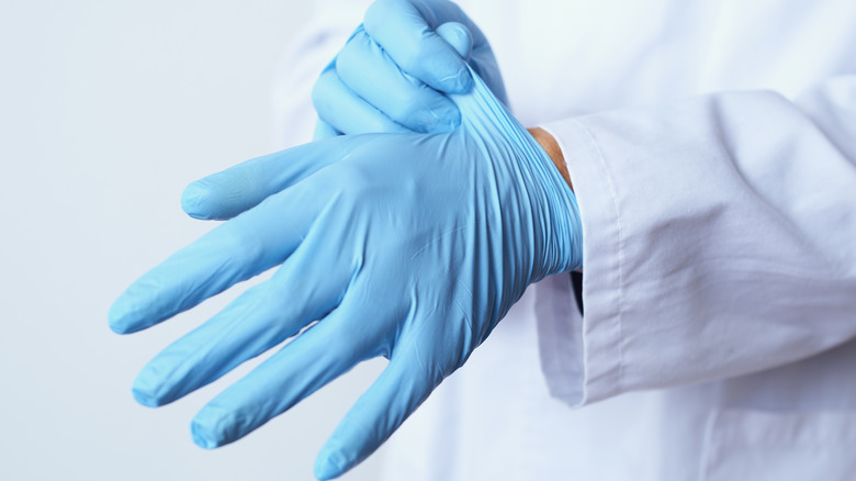 medical professional wearing blue gloves