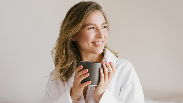 a woman holding a cup