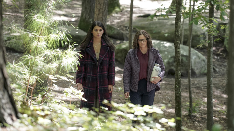 Sofia Black-D'Elia and Ally Sheedy walking in woods