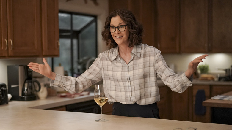 Ally Sheedy smiling in kitchen set