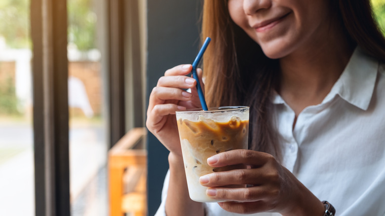 woman enjoying iced coffee