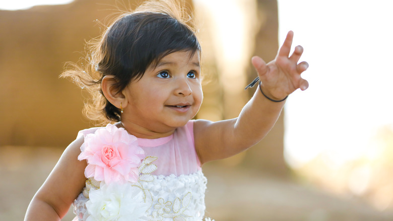 Baby girl reaching out