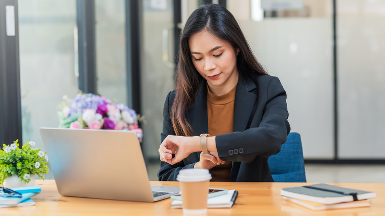 Business woman setting her watch