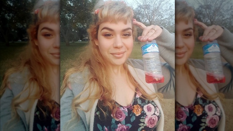 Blonde Amber Rachdi, outdoors with water bottle