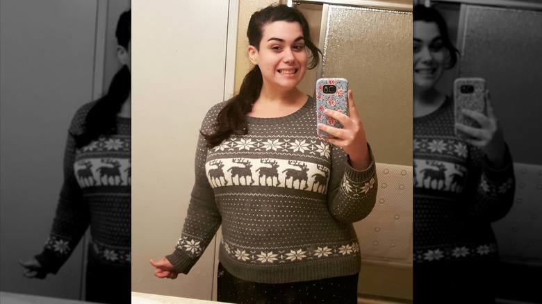 Amber Rachdi mirror selfie in Christmas sweater