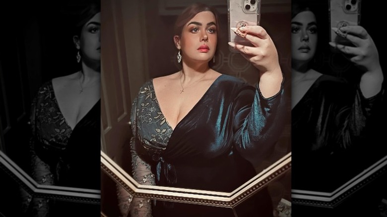 Mirror selfie of Amber Rachdi in formal dress