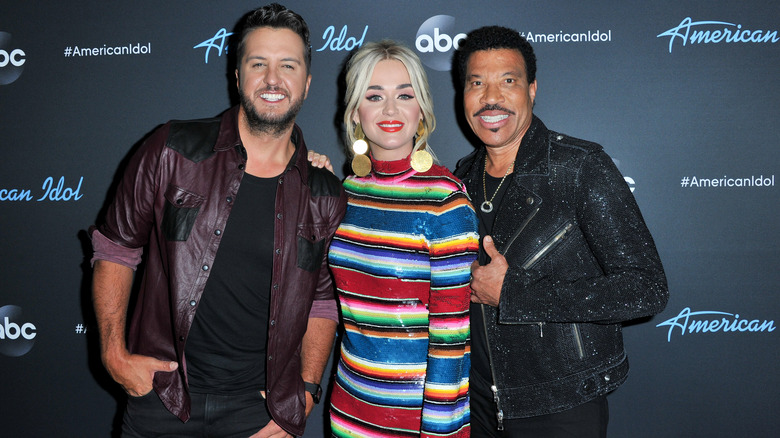 Luke Bryan, Katy Perry, and Lionel Richie's smiling faces posing