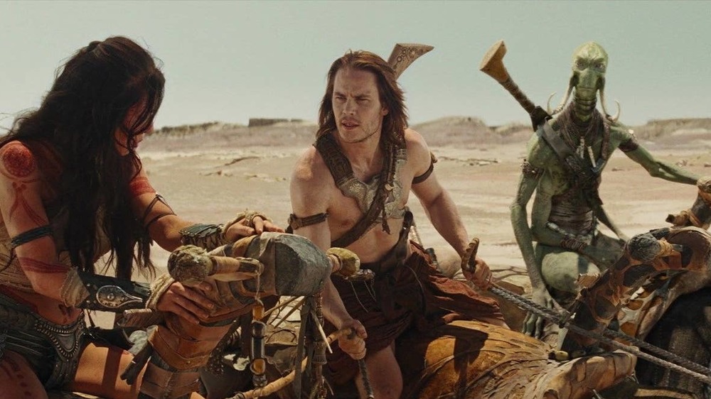 The stars of John Carter riding horses