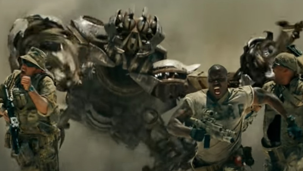 Men running from a transformer in Transformers