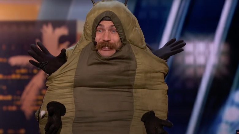 Man dressed like a caterpillar performs 