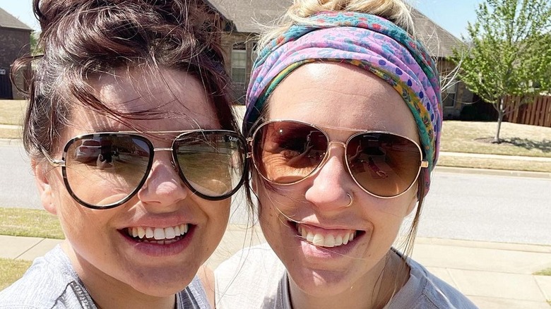 Amy and Jill Duggar smiling in the sun