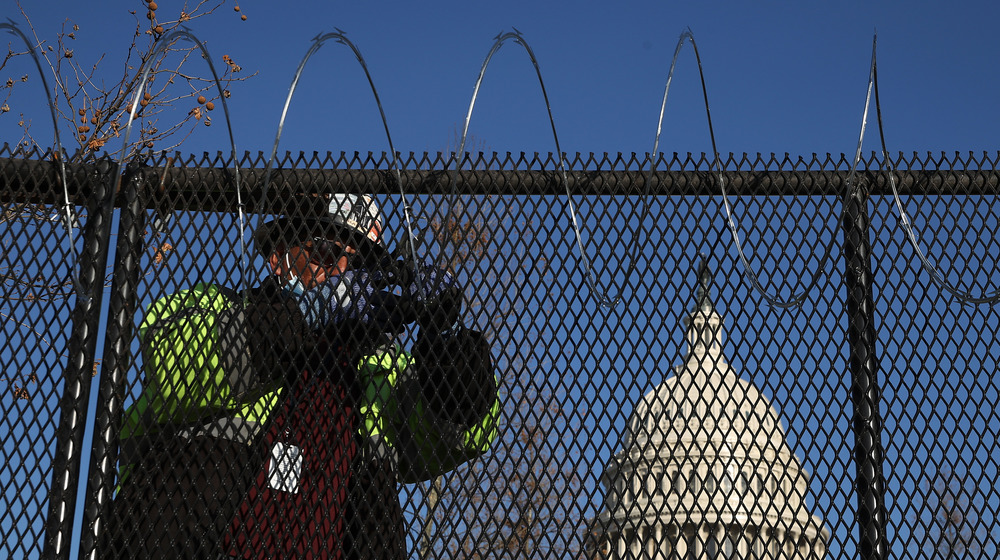 Security guard behind fence at Capitol