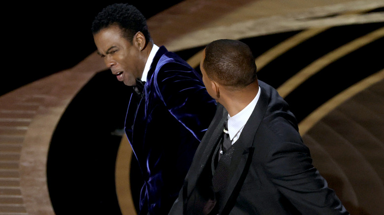 Will Smith slaps Chris Rock onstage at the 2022 Oscars