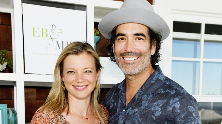 Amy Smart posing with her husband Carter Oosterhouse