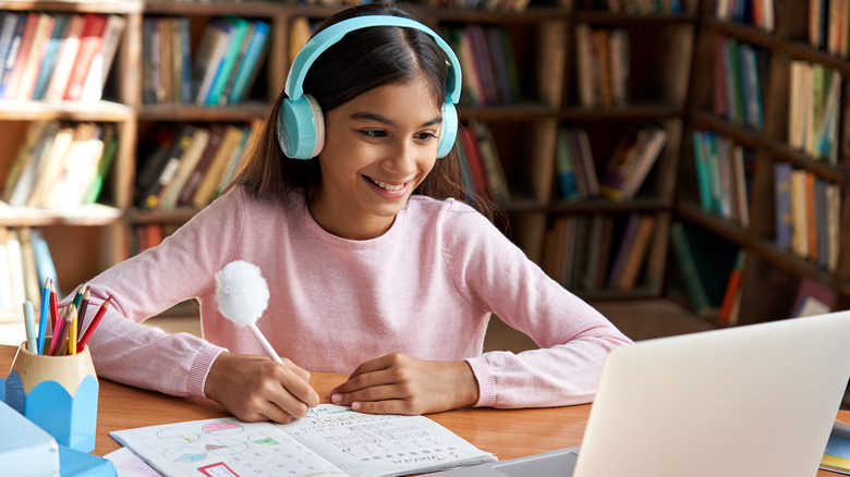 Girl wearing blue headphones