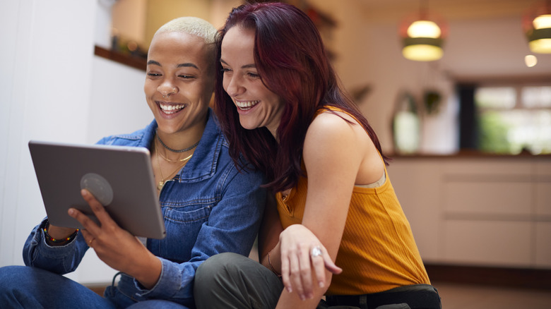 smiling women using a tablet